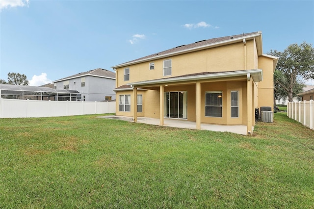 back of house featuring a patio, central AC, a yard, and glass enclosure