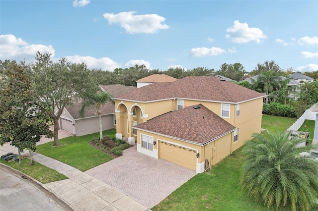 view of front of property with a garage and a front yard