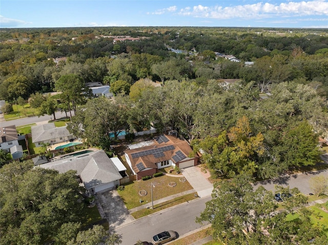 birds eye view of property featuring a wooded view and a residential view