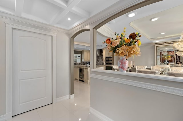 hall featuring ornamental molding, coffered ceiling, light tile patterned floors, beam ceiling, and wine cooler