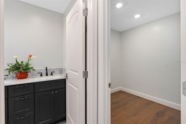 bathroom with vanity and wood-type flooring