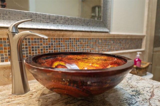 interior details featuring tasteful backsplash and a sink