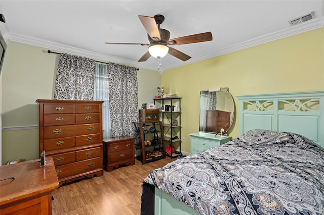 bedroom featuring light hardwood / wood-style flooring, ceiling fan, and ornamental molding