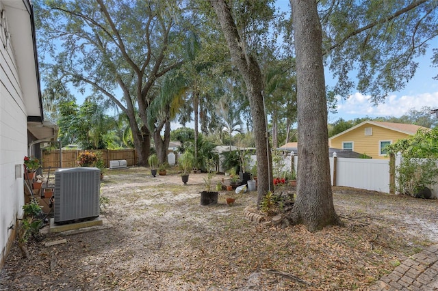 view of yard with central AC unit and a fenced backyard