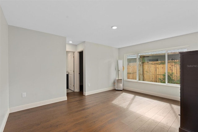 unfurnished room with recessed lighting, baseboards, and wood finished floors