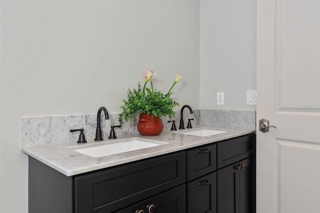 bathroom with a sink and double vanity