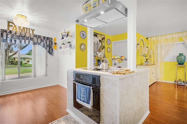 kitchen with hardwood / wood-style floors, oven, and gas cooktop