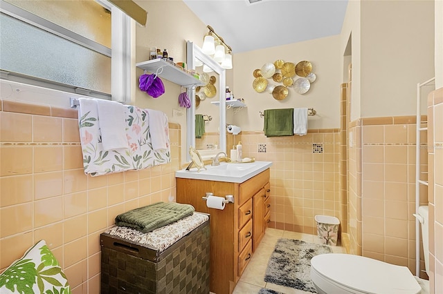 bathroom with tile walls, tile patterned flooring, vanity, and toilet