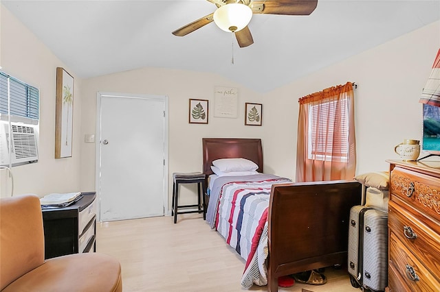 bedroom featuring light wood-type flooring, vaulted ceiling, and a ceiling fan