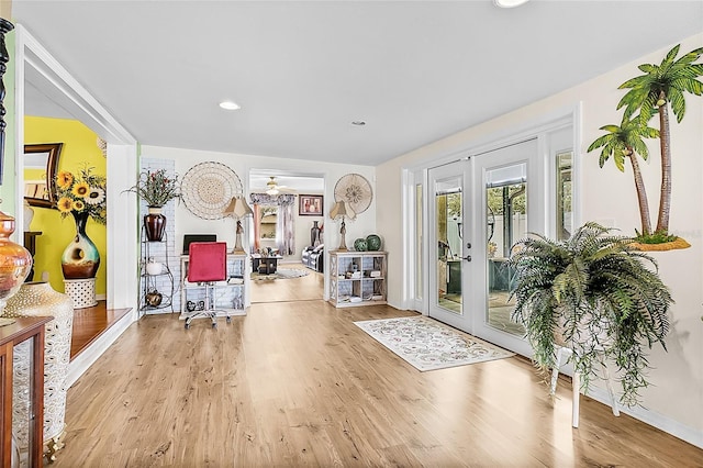 workout area with french doors, wood finished floors, and recessed lighting