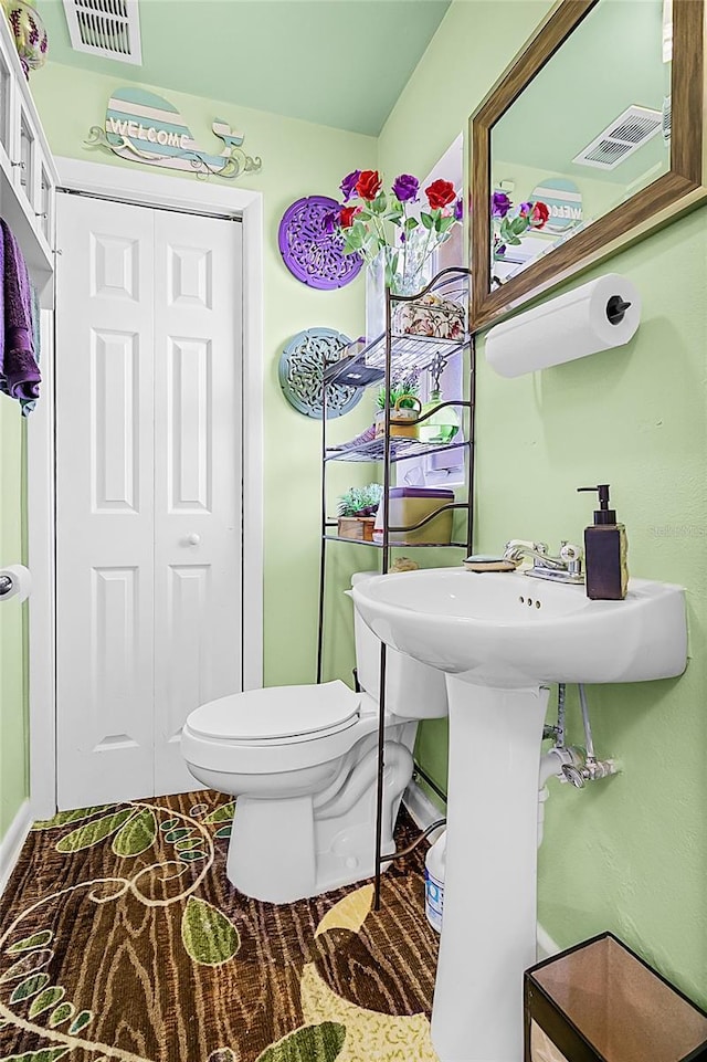 bathroom featuring visible vents and toilet