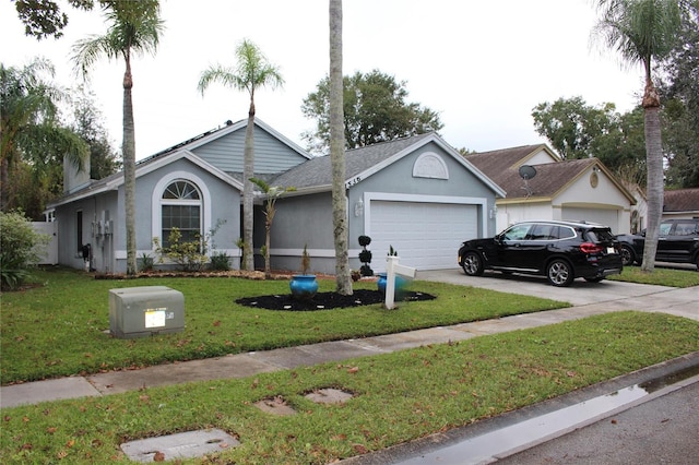 single story home with a garage and a front lawn