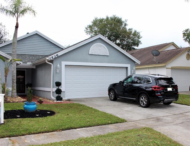 ranch-style house with a garage and a front lawn