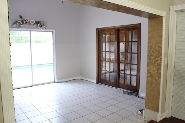 tiled spare room featuring french doors