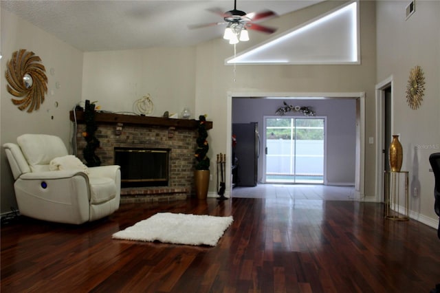 living room featuring a fireplace, hardwood / wood-style flooring, and ceiling fan