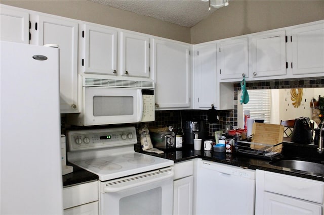 kitchen with white cabinets, a textured ceiling, and white appliances