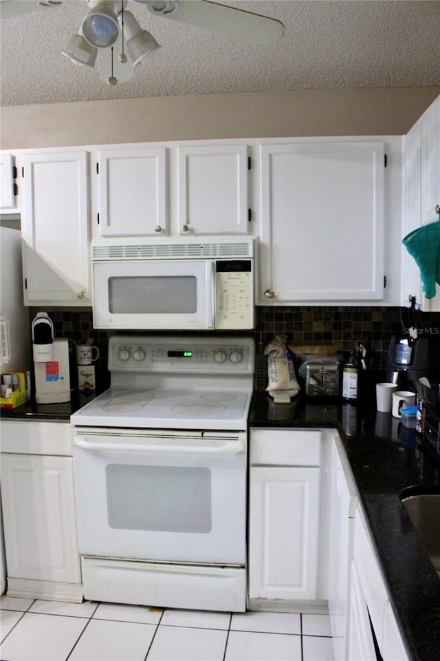 kitchen featuring tasteful backsplash, white cabinetry, white appliances, and a textured ceiling