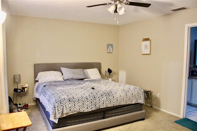 bedroom with a textured ceiling, ceiling fan, and carpet floors