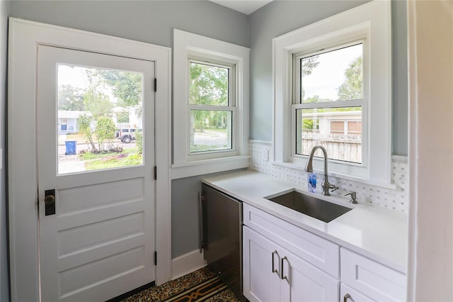 doorway with a wealth of natural light and sink