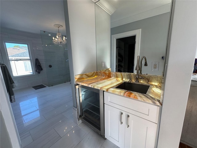 bathroom with tile patterned floors, an inviting chandelier, vanity, walk in shower, and wine cooler