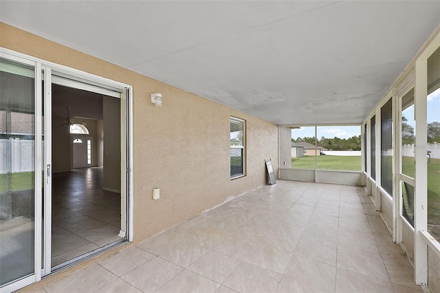 unfurnished sunroom featuring plenty of natural light