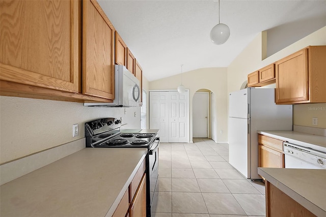 kitchen featuring pendant lighting, stainless steel appliances, lofted ceiling, and light tile patterned floors