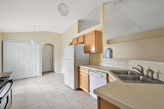 kitchen featuring light tile patterned floors, pendant lighting, sink, white appliances, and lofted ceiling