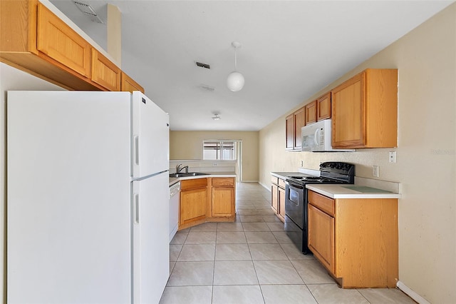 kitchen featuring kitchen peninsula, sink, white appliances, and light tile patterned flooring