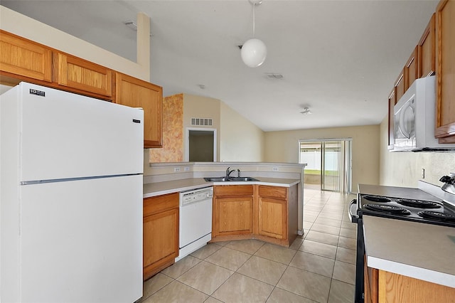 kitchen with sink, kitchen peninsula, light tile patterned floors, white appliances, and vaulted ceiling