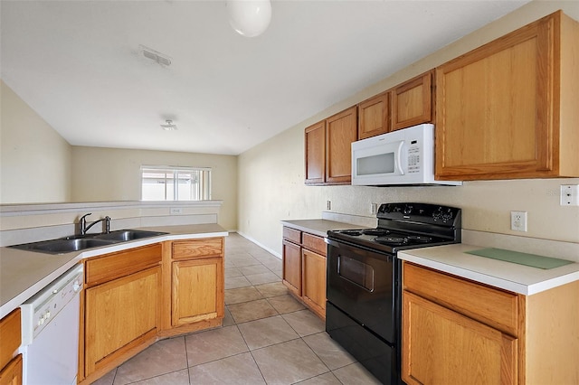 kitchen with white appliances, sink, and light tile patterned flooring