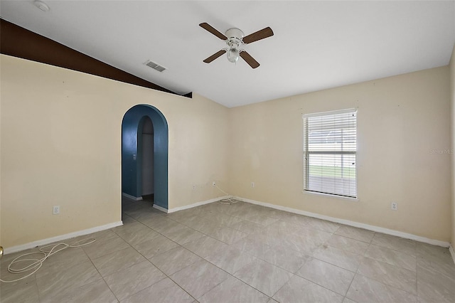 tiled empty room with lofted ceiling and ceiling fan