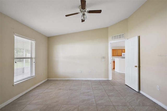 spare room with light tile patterned flooring and ceiling fan