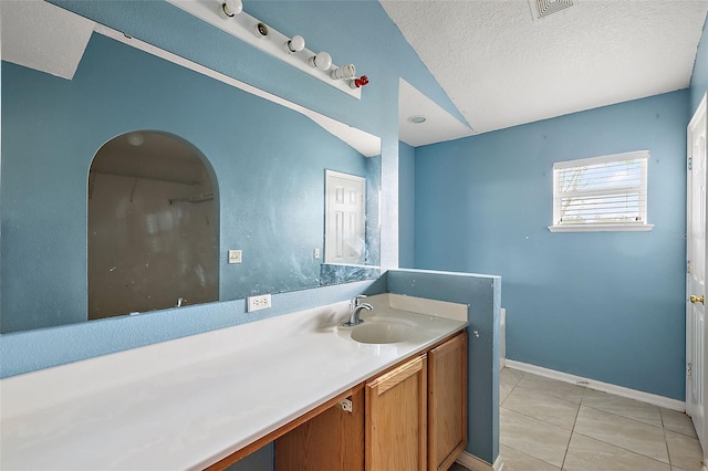 bathroom with vanity, tile patterned flooring, and a textured ceiling