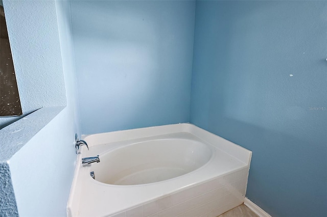 bathroom with tiled tub