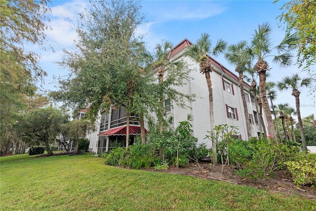 view of property exterior with a lawn