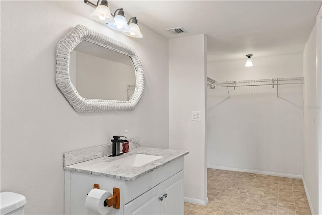 bathroom featuring vanity and toilet