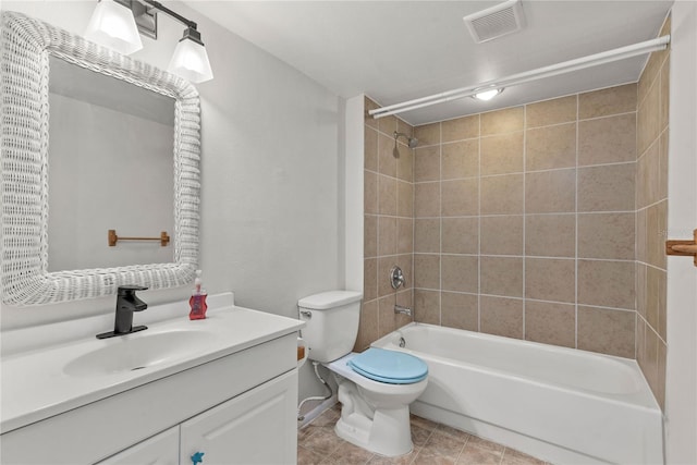 full bathroom featuring toilet, tiled shower / bath combo, vanity, and tile patterned flooring