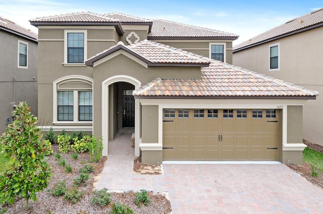 mediterranean / spanish house featuring a garage