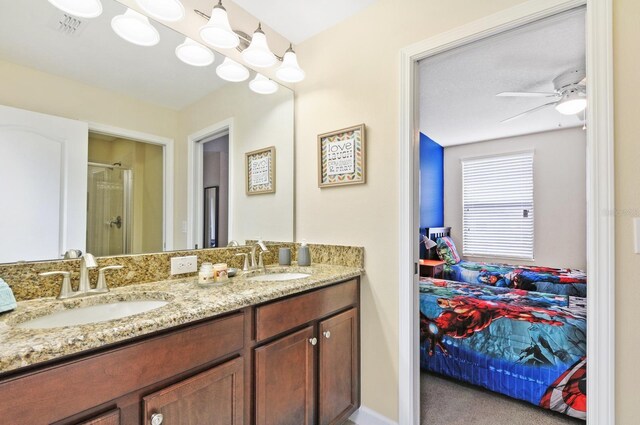 1423 Thunderbird Rd, Davenport, FL 33896 - bathroom with ensuite bathroom, double vanity, a shower stall, and a ceiling fan