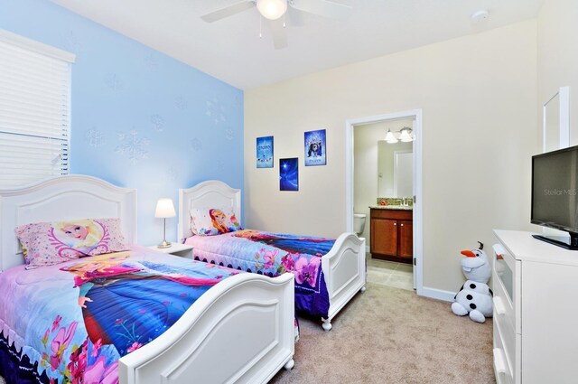 1423 Thunderbird Rd, Davenport, FL 33896 - bedroom featuring light colored carpet, ensuite bath, ceiling fan, and baseboards