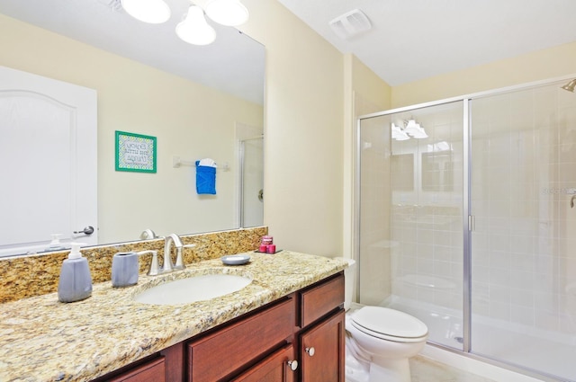 bathroom featuring toilet, an enclosed shower, and vanity