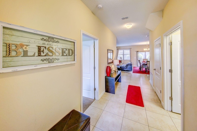 1423 Thunderbird Rd, Davenport, FL 33896 - hallway with a chandelier, light tile patterned floors, and baseboards