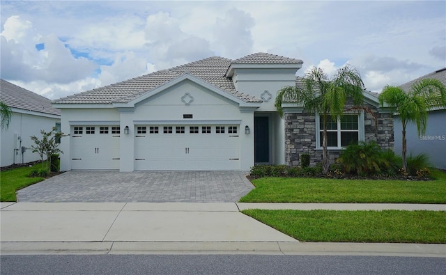 1490 Olympic Club Blvd, Champions Gate, FL 33896 - mediterranean / spanish-style house with a tiled roof, a garage, decorative driveway, and stucco siding