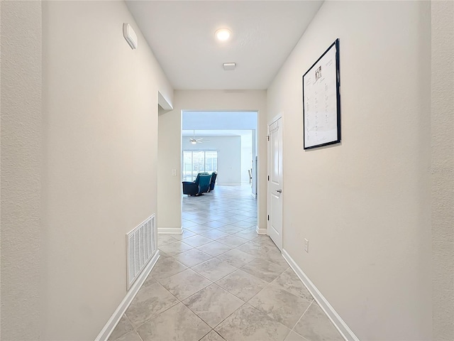 hallway featuring light tile patterned floors