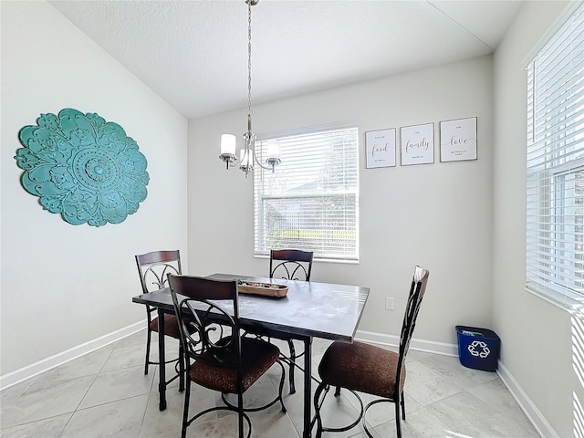 tiled dining room with a chandelier, a textured ceiling, and lofted ceiling