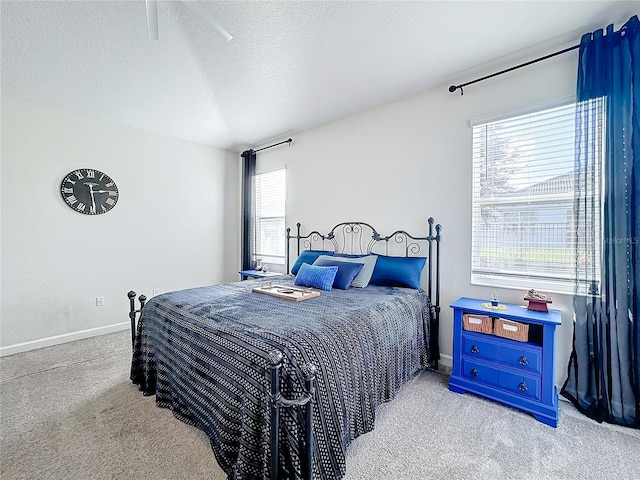 carpeted bedroom featuring multiple windows, a textured ceiling, and ceiling fan