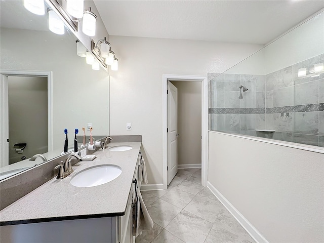 bathroom featuring vanity and tiled shower