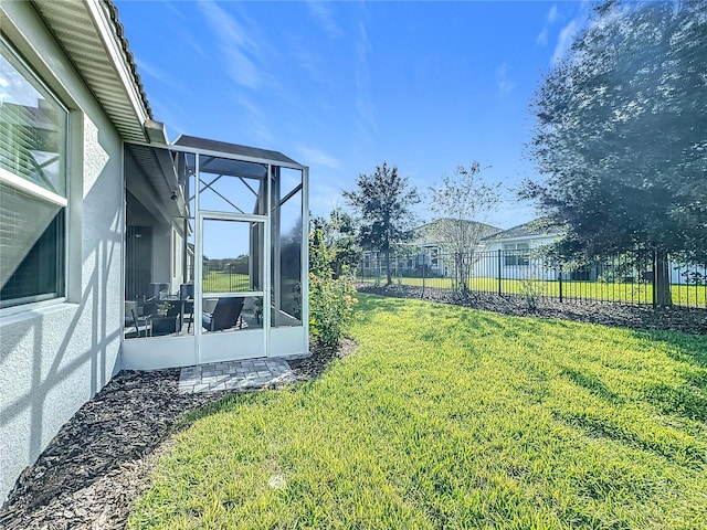 view of yard with glass enclosure