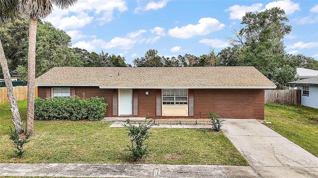 single story home featuring a front lawn