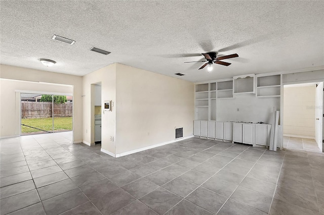 unfurnished room featuring a textured ceiling, tile patterned flooring, and ceiling fan